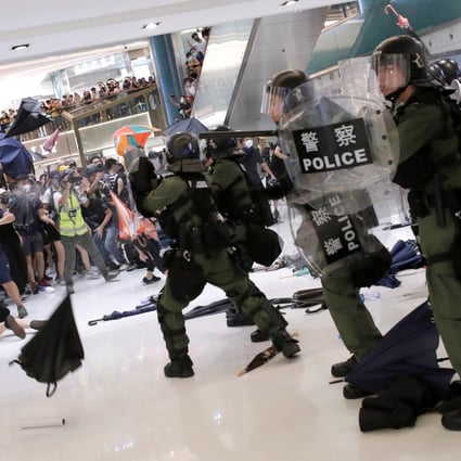 Riot police use pepper spray to disperse pro-democracy activists inside New Town Plaza mall. Photo: Reuters