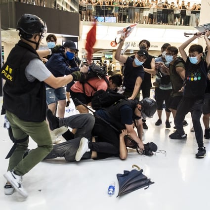 Protesters attack police at New Town Plaza shopping centre on Sunday. Photo: Bloomberg