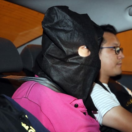 A suspect arrested in connection with the Yuen Long violence on Sunday night is escorted to Tin Shui Wai police station. Photo: Winson Wong