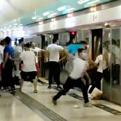 A screen grab from a video shows a group of people in white with wooden sticks chasing and assaulting passengers at the Yuen Long MTR station. Photo: Handout