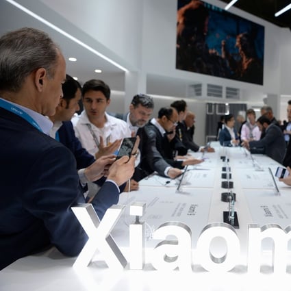 Visitors test the new Xiaomi Mi 9 smartphone at the Mobile World Congress (MWC) in Barcelona on February 27, 2019. Photo: AFP