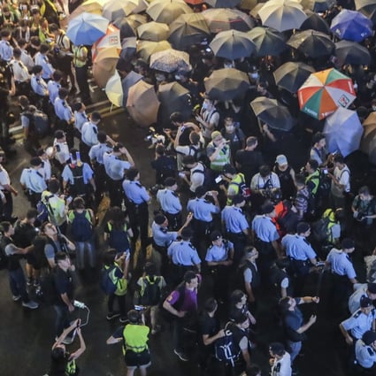 Police lines hold back protesters at an action in Tsim Sha Tsui. Photo: Edmond So