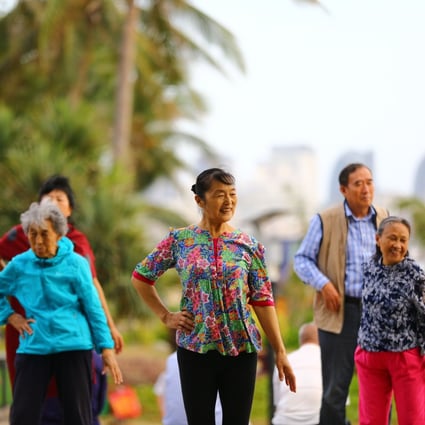 Elderly people walk along the beach in Sanya in China’s Hainan province in February 2017. The island province is fast becoming known as “China’s Florida”, drawing masses of retirees fleeing the biting cold of their hometowns. Photo: AFP