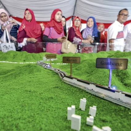 Visitors to a showroom view a scale model of the East Coast Rail Link in Kuantan. Photo: AP