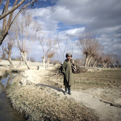 An Afghan boy outside the Musa Qala district-centre military base in Afghanistan. The Taliban insurgency has led to numerous bombings and killings since the 1990s. Photo: AFP