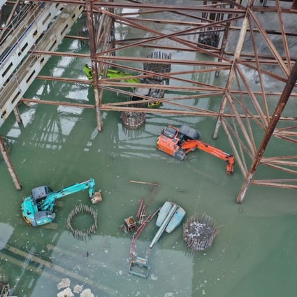 Construction equipment is submerged by flooding on Thursday at the building site of the West Kowloon Cultural District. Photo: Winson Wong