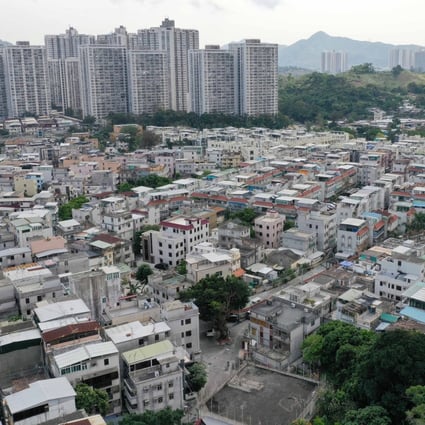Indigenous village houses in Yuen Long, with housing estates in the background. Photo: Winson Wong