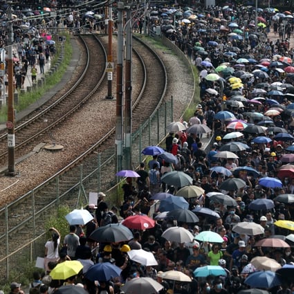 Protesters line the train tracks in Yuen Long during Saturday’s demonstration. Photo: Xiaomei Chen