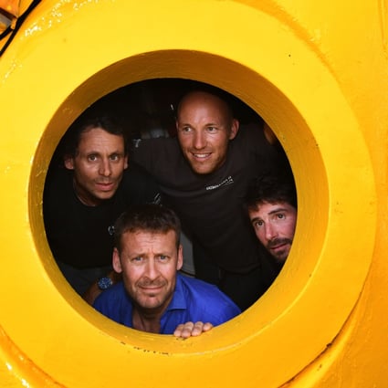 French biologist, marine naturalist and photographer, Laurent Ballesta (bottom poses inside his diving chamber with his crew in Marseille. Photo: AFP