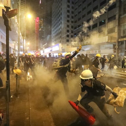 Riot police fired tear gas at anti-extradition bill protesters as they marched towards the central government’s liaison office on Sunday. Photo: Felix Wong