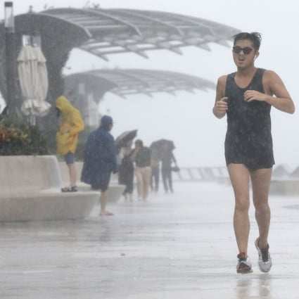 A man runs along Tsim Sha Tsui waterfront as Tropical Storm Wipha approaches Hong Kong. Photo: May Tse