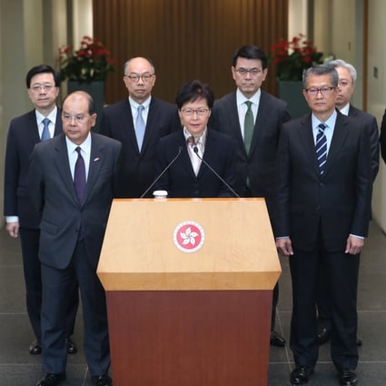 Chief Executive Carrie Lam, flanked by eight of her ministers, addresses the press in Tamar. Photo: Sam Tsang