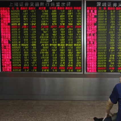 A Chinese investor watches stock prices in front of an electronic board at a securities brokerage house in Beijing on August 2, 2019. Photo: EPA-EFE