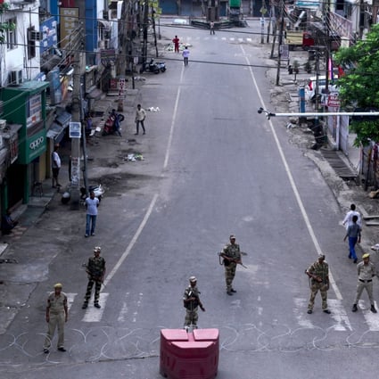 Security personnel stand guard on a deserted street in Jammu on August 6. India has revoked the special status of the Muslim-majority state of Jammu and Kashmir. Photo: AFP