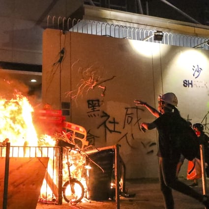 Protesters start a fire at Sha Tin Police Station. Photo: Felix Wong