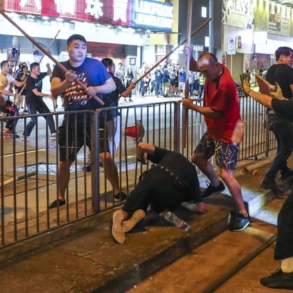 Violence on the streets of North Point on Sunday, as men armed with poles attacked anti-government protesters. Photo: SCMP / Sam Tsang