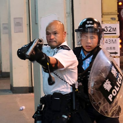 The officer faced intense criticism for aiming a gun directly at protesters. Photo: Reuters