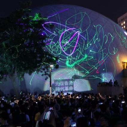 Protesters light up the Hong Kong Space Museum in Tsim Sha Tsui in protest after police arrested a student for possession of laser pointers, which authorities claim is an offensive weapon. Photo: Sam Tsang