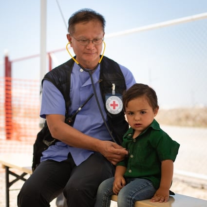Walter Leung Wai-yin, an intensive care nurse from Hong Kong, with two-year-old Saad, at a field hospital in Al Hol camp, Syria. Photo: ICRC
