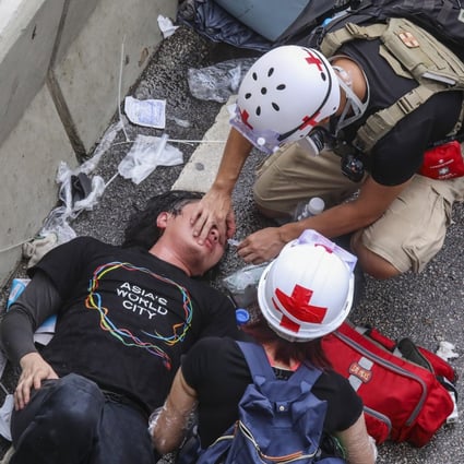 An injured protester is treated after clashing with police on July 1, 2019. Photo: K. Y. Cheng