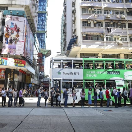 Commuters divert to other transport methods on King's Road as anti-government protesters stopped MTR services from departing during a citywide strike on 5 August 2019. Photo: Winson Wong