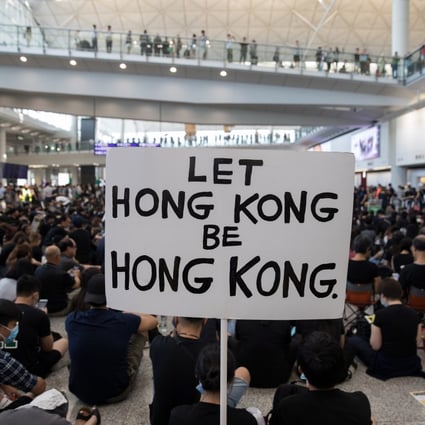 Protesters rally inside the arrivals hall of Hong Kong International Airport on August 9, where they gathered for a three-day sit-in against the suspended extradition bill. Photo: EPA-EFE
