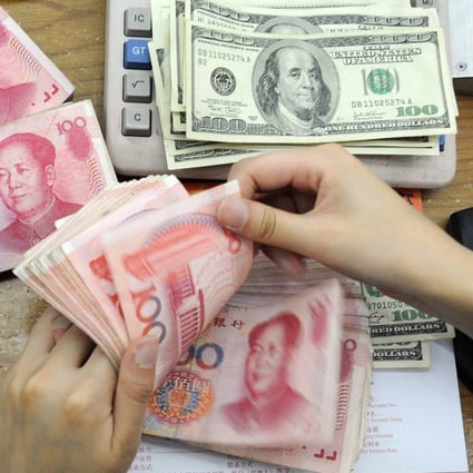 China's central bank set the midpoint exchange rate at 7.0211 on Monday, the third consecutive trading day that Beijing has set a rate weaker than 7 to the US dollar. Photo: AFP