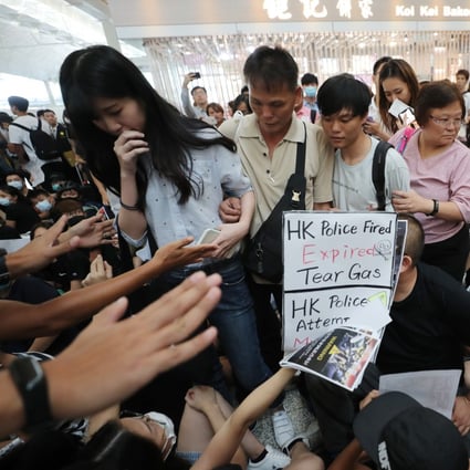 Travellers attempting to navigate through the crowd of anti-government protestors at the departure hall of the Hong Kong International Airport, Chek Lap Kok on 13 August 2019. Photo: SCMP / Sam Tsang