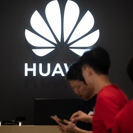 Employees work at a Huawei store in Dongguan, Guangdong province on August 9, 2019. Photo: AFP