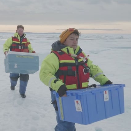 Scientists carry boxes of ice cores drilled from the Canadian Arctic. Photo: Reuters