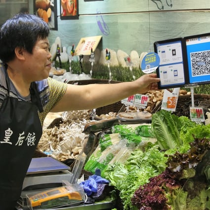 A Hong Kong merchant uses Ant Financial Services Group's Alipay at her stall in Po Tat Market. Photo: Edmond So