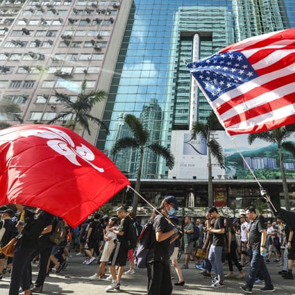 A protester holds a US flag during a march on Hong Kong Island last month. Photo: Xiaomei Chen