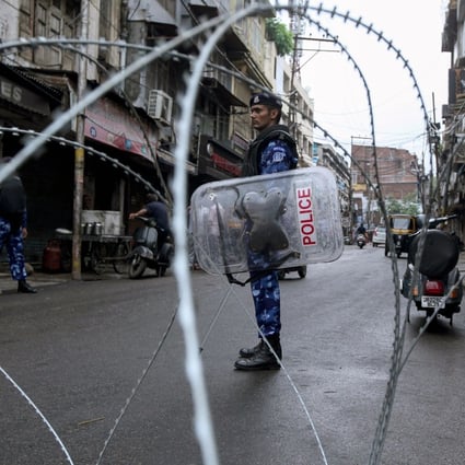 Rapid Action Force personnel stand guard at a roadblock in Jammu city. Photo: AFP