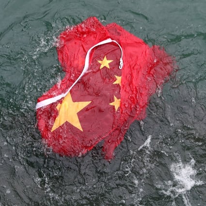 The Chinese flag was thrown into Victoria Harbour. Photo: Sam Tsang