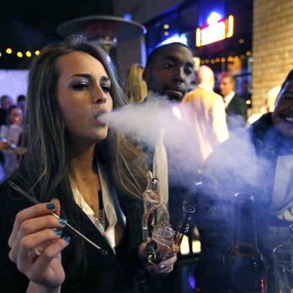 A young woman smokes marijuana at a party in Denver, Colorado. Photo: AP