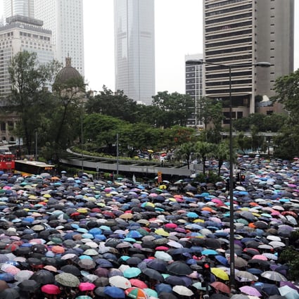 Umbrellas go up in Central as thousands of teachers brave heavy rain to show solidarity with their students. Photo: Dickson Lee
