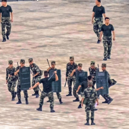 Members of the People's Armed Police Force stage an anti-riot drill in Shenzhen. Photo: EPA-EFE