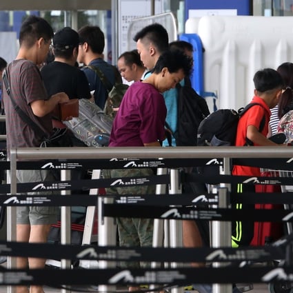 Travellers queue up to enter Hong Kong International Airport. Security measures have been strengthened to prevent anti-government protesters from occupying the airport again. Photo: David Wong