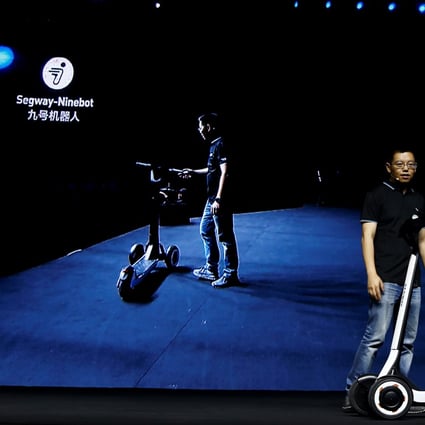 Ninebot President Wang Ye unveils semi-autonomous scooter KickScooter T60 that can return itself to charging stations without a driver, at a Segway-Ninebot product launch event in Beijing, China August 16, 2019. REUTERS/Florence Lo