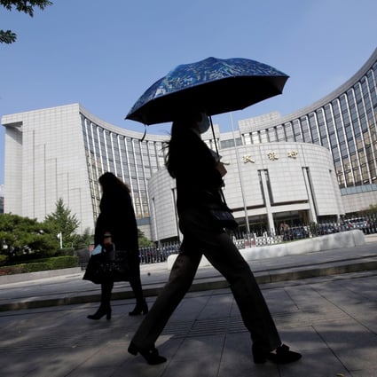 People walk past the headquarters of the People’s Bank of China. China’s central bank is close to launching is own sovereign digital currency allowing it to tighten its grip on the nation’s deposit pool. Photo: Reuters