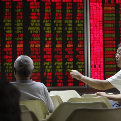 Chinese investors in front of an electronic board showing stock prices at a securities brokerage house in Beijing on 13 June 2019. Contrary to global conventions, China’s stock market represent gains and advances in red, using green to denote losses and declines. Photo: EPA-EFE