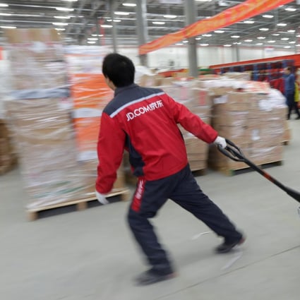 A worker moves goods at a JD.com logistics centre in Langfang, Hebei province, China. Photo: Reuters