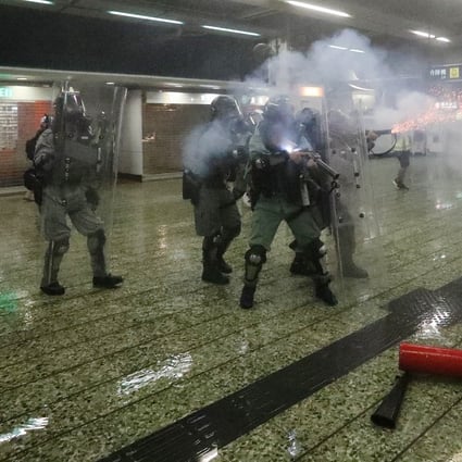 Riot police fire tear gas inside Kwai Fong MTR station during clashes with anti-government protesters. Photo: Felix Wong