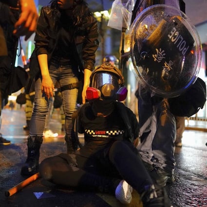 Police arrest a demonstrator during a protest on August 25 in Tsuen Wan. Photo: AP