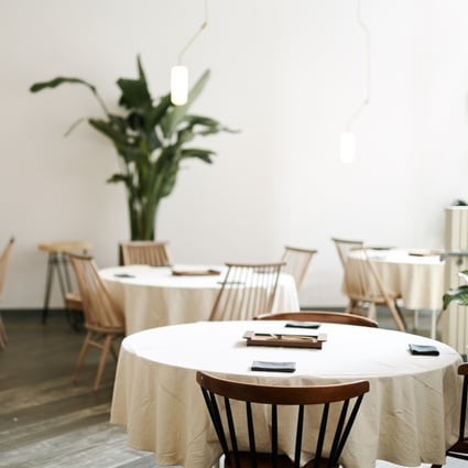 Nectar’s interiors are stark, with white tablecloths and plant accents.