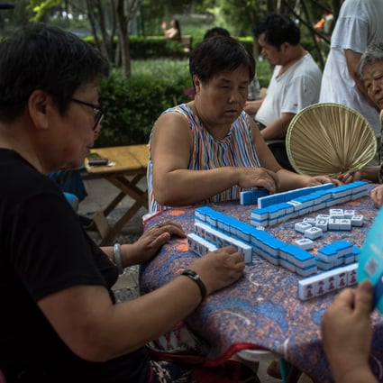 A game of mahjong being played in public in Beijing, China. Photo: EPA-EFE