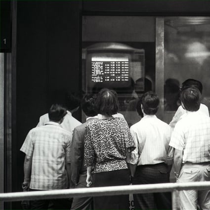 On May 22, 1989 Hong Kong stock prices suffered their heftiest one-day fall since the 1987 crash as waves of panic selling, prompted by the political crisis in China, swept through the local stock market. Pictured are anxious investors watching share prices plunge. Photo: SCMP
