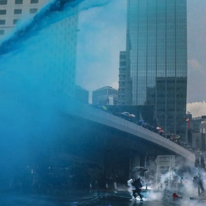 Blue dye streams from a police water cannon. A reporter from Taiwan who was doused said the liquid induced a ‘burning pain’. Photo: Felix Wong