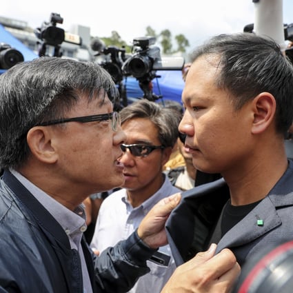 Pro-Beijing lawmaker Junius Ho Kwan-yiu (left) argues with pro-democracy lawmaker Dennis Kwok Wing-hang before a demonstration of a water cannon-equipped vehicle at the compound of the Police Tactical Unit in Fanling on August 12. Photo: Sam Tsang