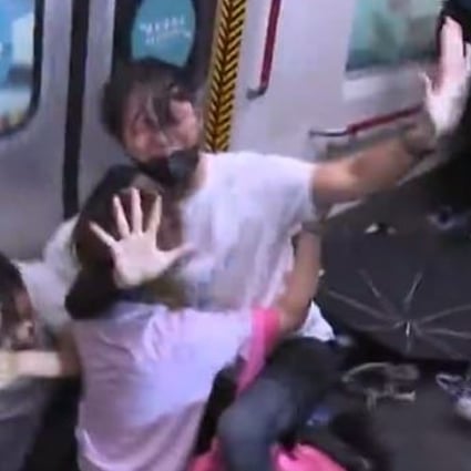 About five officers from the Special Tactical Squad hit four commuters inside an MTR train at Prince Edward station. Photo: TVB